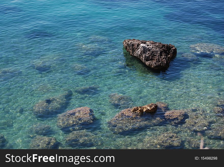 Big rocks in the beautiful clear water surrounding Corfu Island in Greece. Big rocks in the beautiful clear water surrounding Corfu Island in Greece.