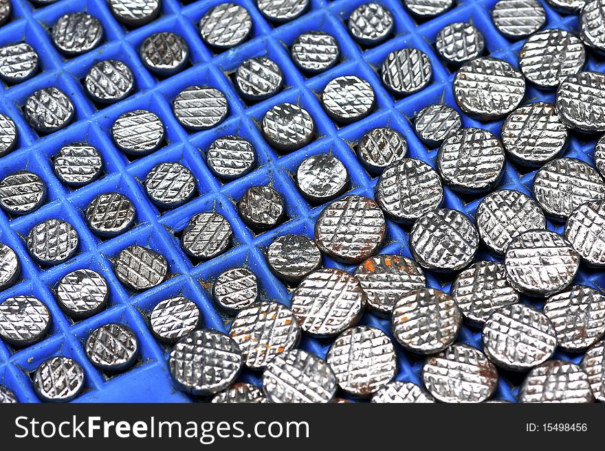 Many nail steel head on the floor blue plastic