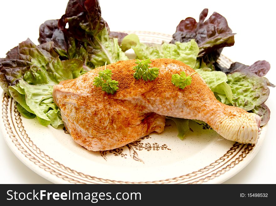 Raw chickens thighs seasoned with salad