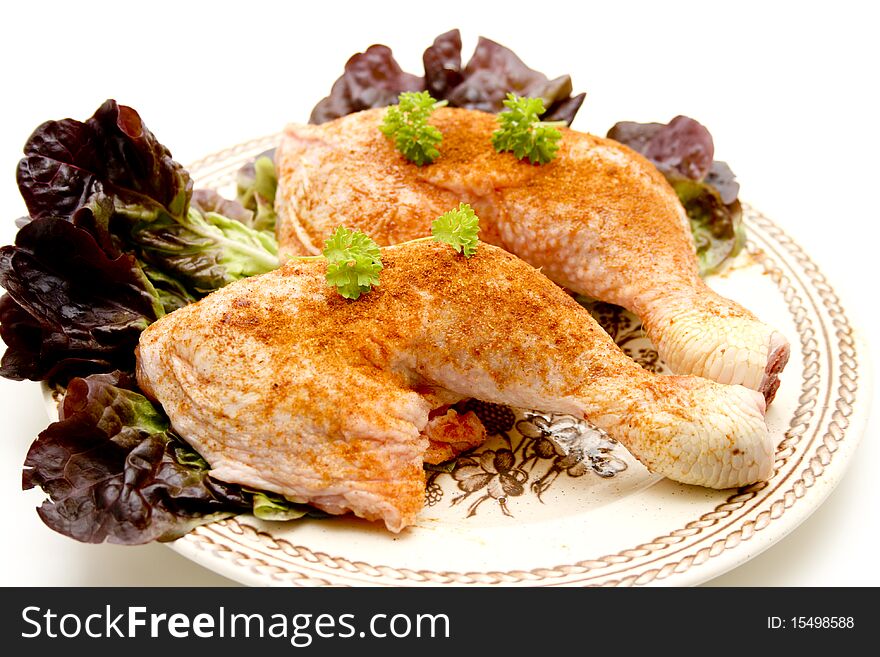 Raw chickens thighs seasoned with lettuce leaf