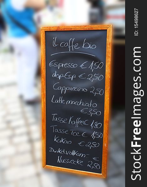 A black board with offers for drinks and cake with integrated prices. A black board with offers for drinks and cake with integrated prices.