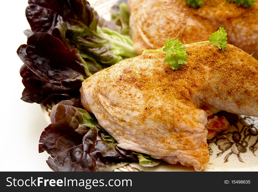 Raw chickens thighs seasoned with lettuce leaf