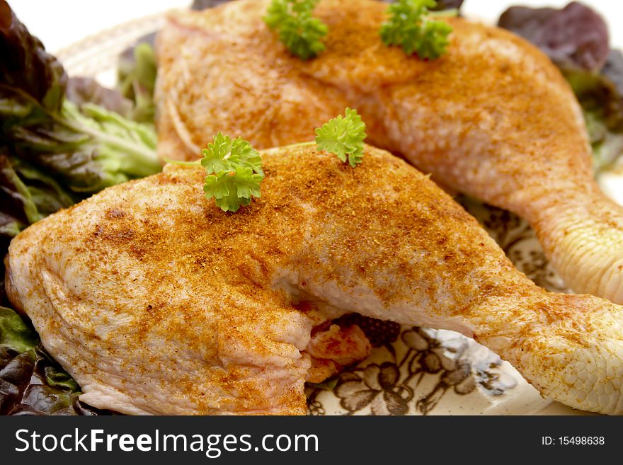 Raw chickens thighs seasoned with lettuce leaf