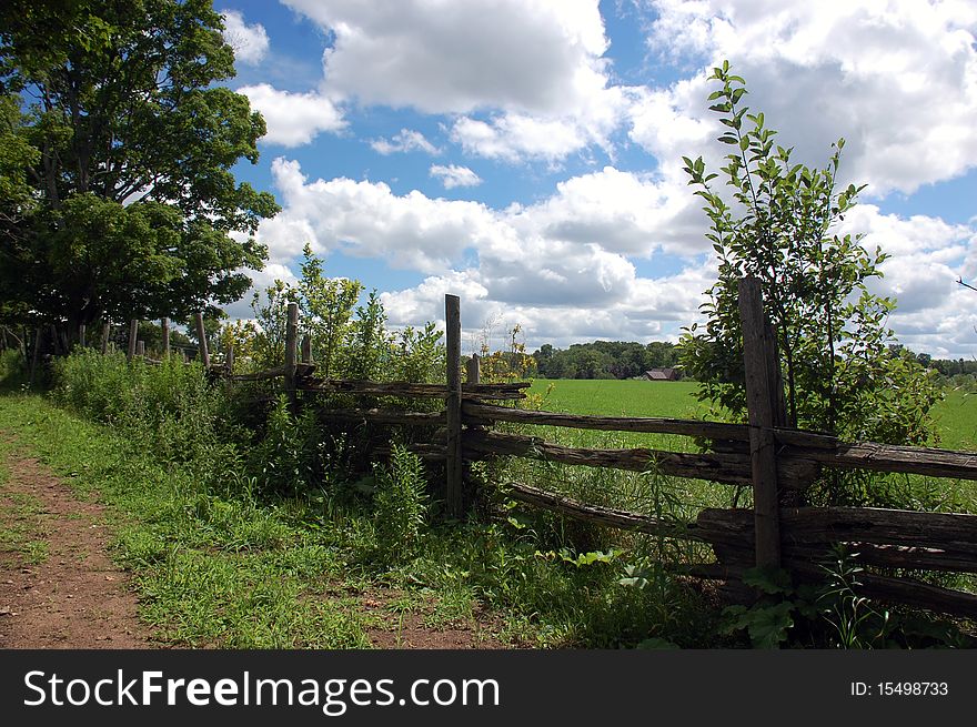 Clouds over a fenced in pasture