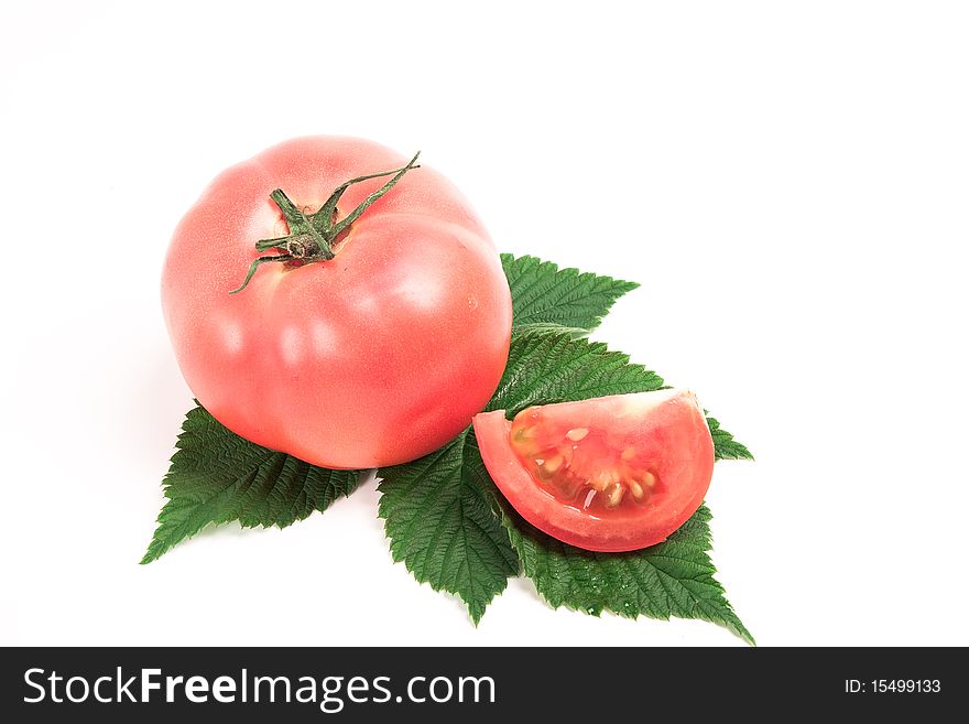 Tomato on a green leaf isolated