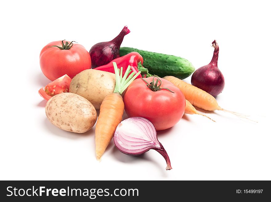 Collection of vegetables: potatoes, tomatoes, onions, cucumbers, peppers, carrots were taken on a white background
