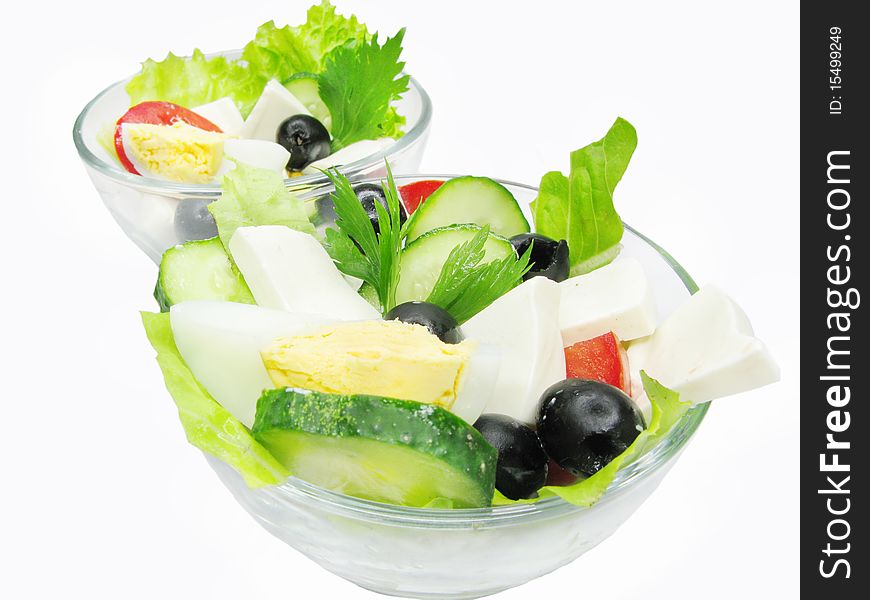 Two bowls of greek salad with cheese olive and tomato