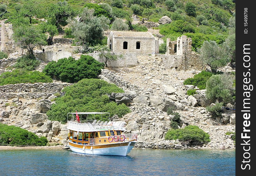 Yacht in aegean sea with view of ancient castle high in mountains. Yacht in aegean sea with view of ancient castle high in mountains