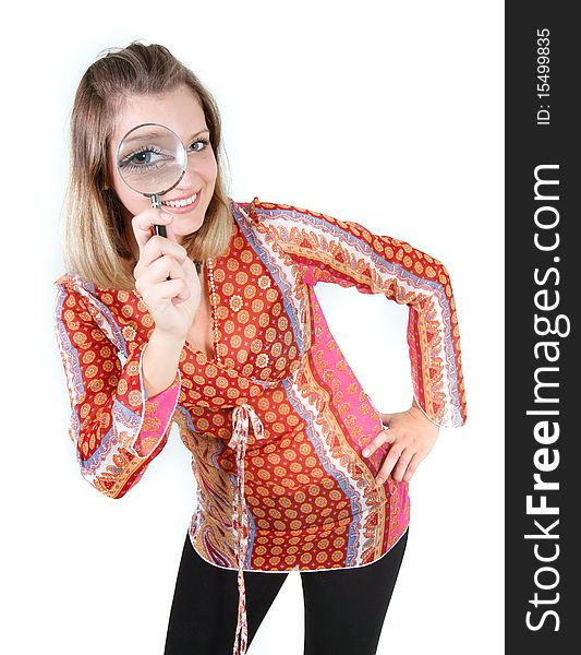 Girl looking through magnifier glass over white