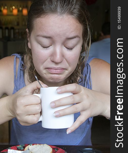 Woman drinking bad coffee first thing in the morning