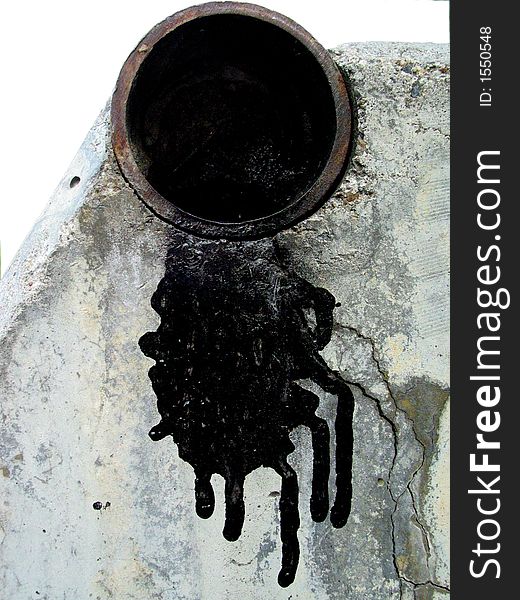 Description: A shot of the opening at the end of a black pipe sitting directly above white concrete.  Black paint is dripping from the pipe onto the concrete. Description: A shot of the opening at the end of a black pipe sitting directly above white concrete.  Black paint is dripping from the pipe onto the concrete.