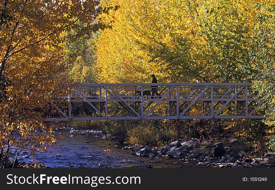 Crossing a bridge over a stream in the autumn. Crossing a bridge over a stream in the autumn