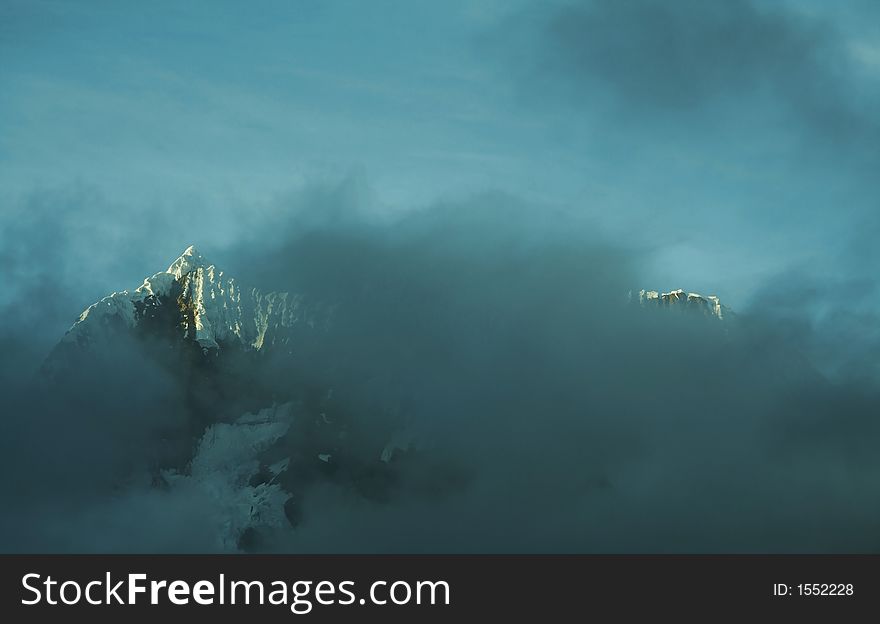 Snowcowered high cordillera mountain in morning misty. Snowcowered high cordillera mountain in morning misty