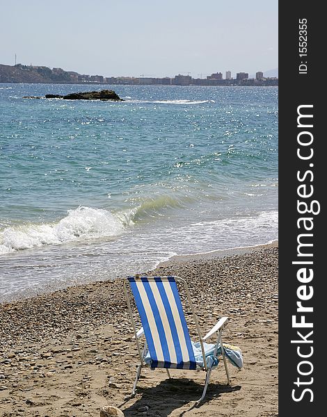 Beach deckchair, seaside, ocean, shingle. Beach deckchair, seaside, ocean, shingle