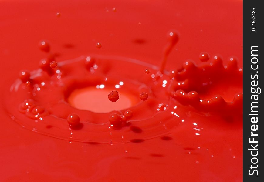 Photo of a splash into red liquid. Photo of a splash into red liquid.