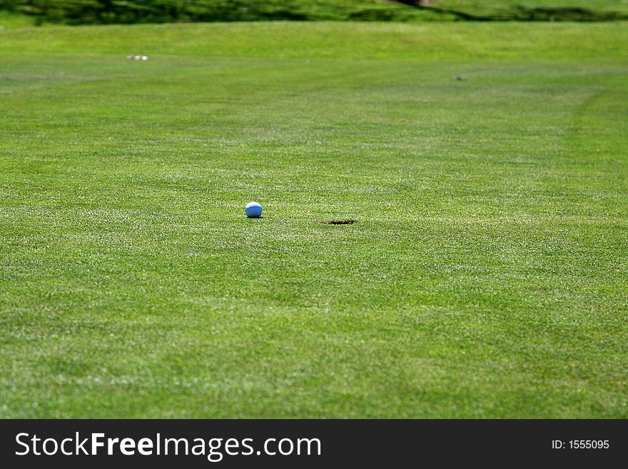 Golf ball reaching the hole. Golf ball reaching the hole