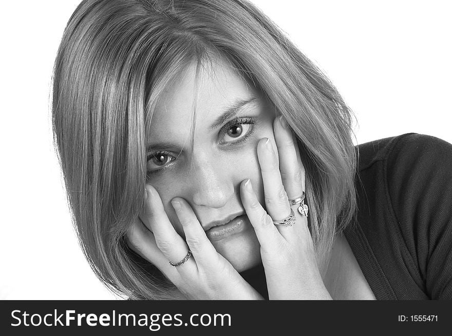 A black and white picture of a woman with her hands on her cheeks in surprise. A black and white picture of a woman with her hands on her cheeks in surprise.