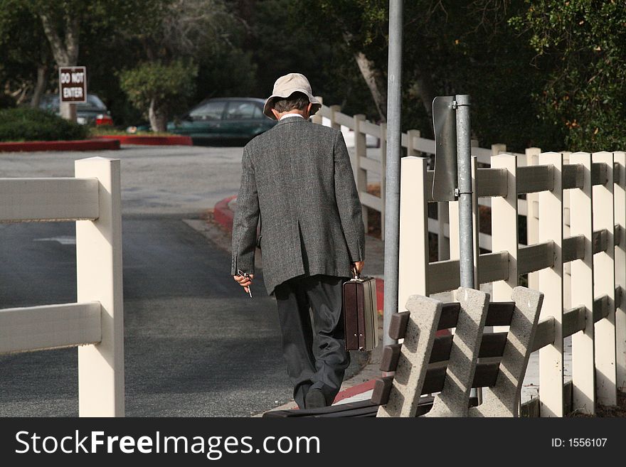 Businessman walking to work in a hippie hat. Businessman walking to work in a hippie hat