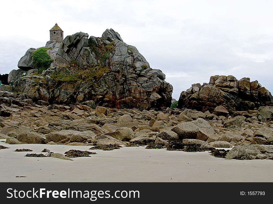 The little village Port-Blanc is situated on the Pink Granite Coast  (CÃ´te de Granite Rose) in Bretagne in France. A little chapel, looking like a lighthouse, is built upon the rocks in the ocean. The little village Port-Blanc is situated on the Pink Granite Coast  (CÃ´te de Granite Rose) in Bretagne in France. A little chapel, looking like a lighthouse, is built upon the rocks in the ocean.