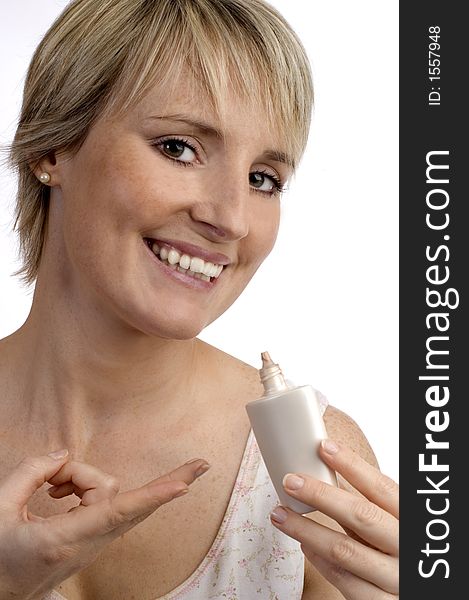 Beautifful young woman with cosmetic in her hand on white. Beautifful young woman with cosmetic in her hand on white