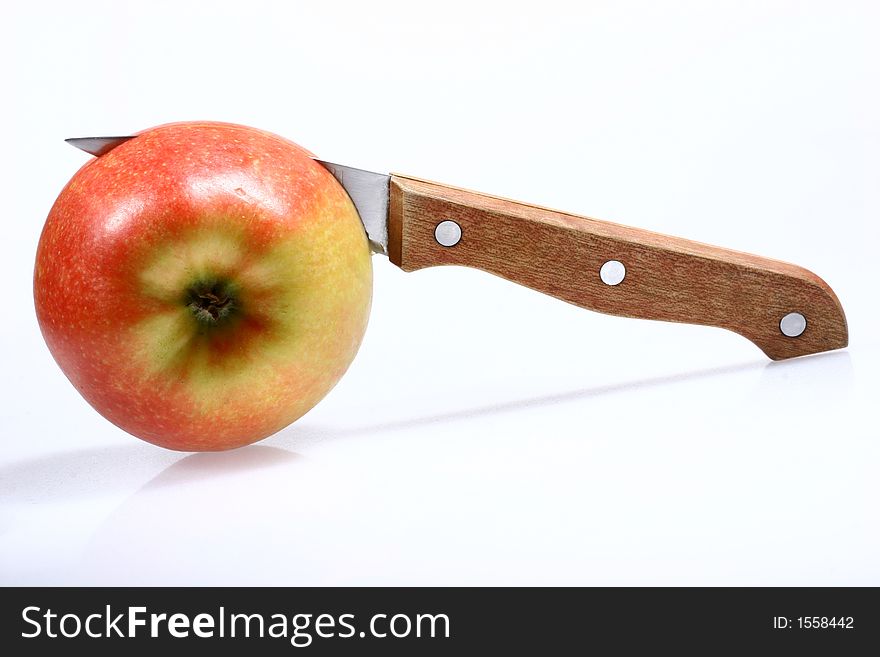 Front view for red apple and knife isolated on white