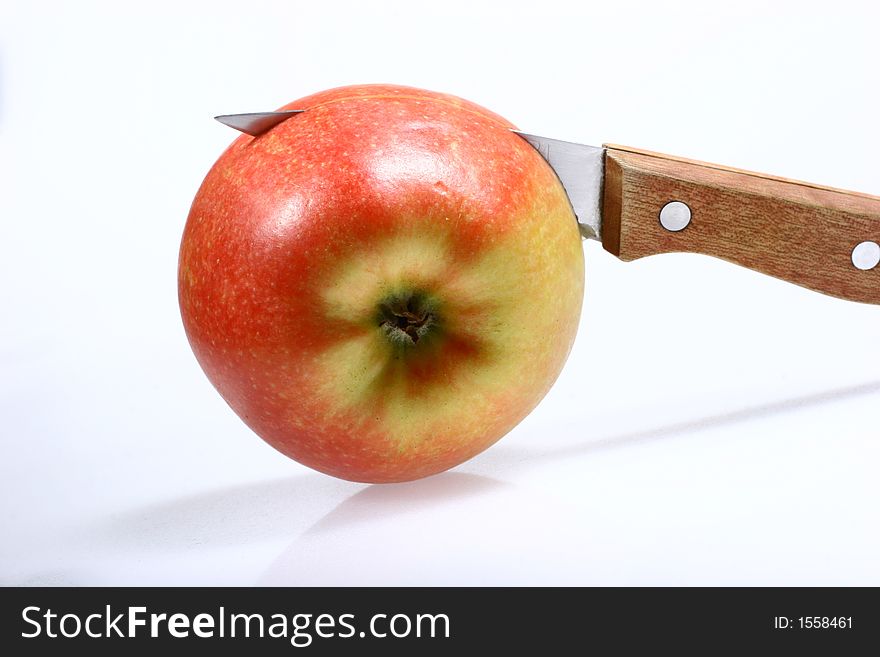 Front view for red apple and knife isolated on white