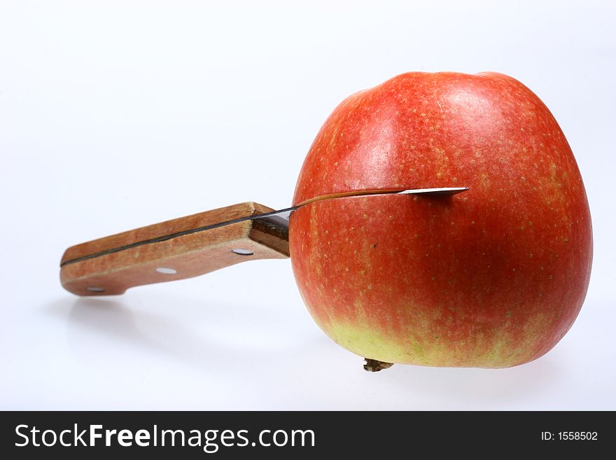 Front view for red apple and knife isolated on white