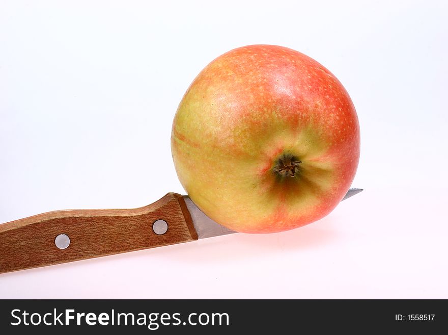 Front view for red apple and knife isolated on white