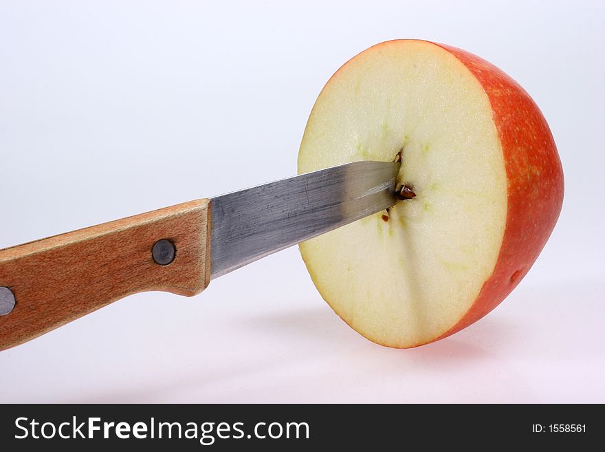 Closeup for red apple and knife isolated on white