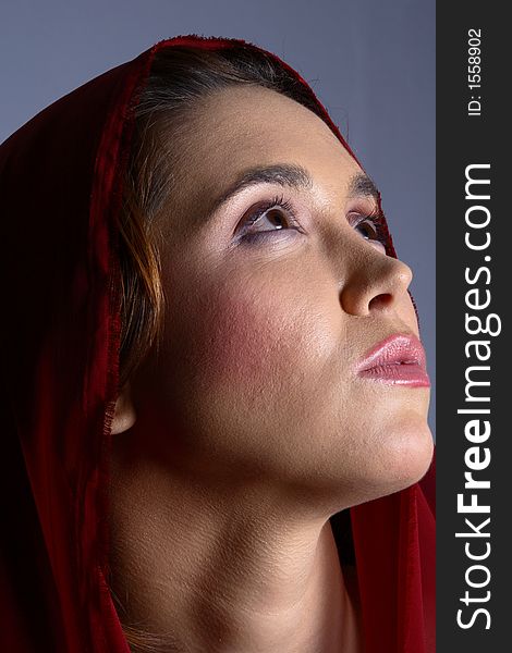 Brunette with red headscarf looking up to the ceiling. Brunette with red headscarf looking up to the ceiling