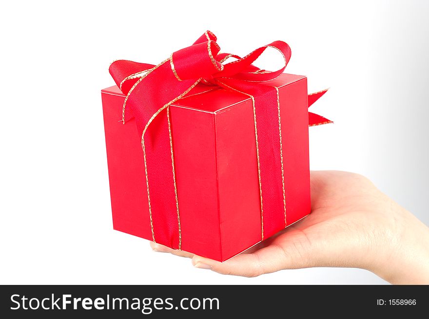 Red gift with red ribbon and bow on white background. Red gift with red ribbon and bow on white background