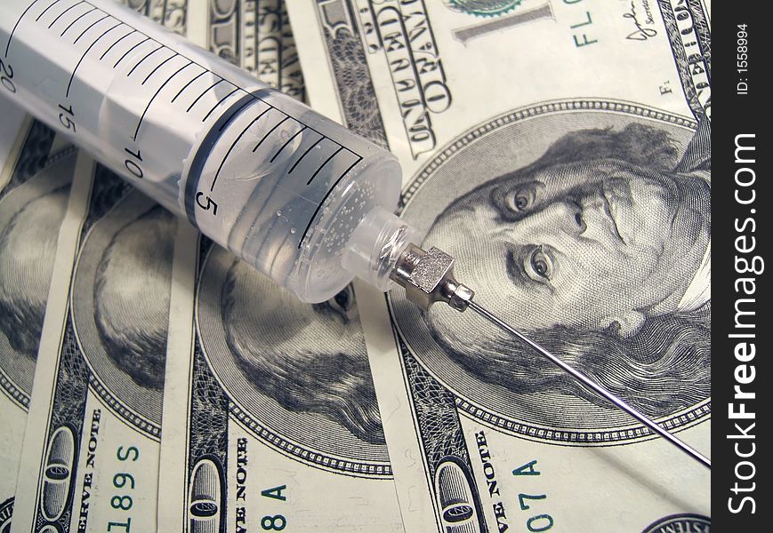 Syringe on money