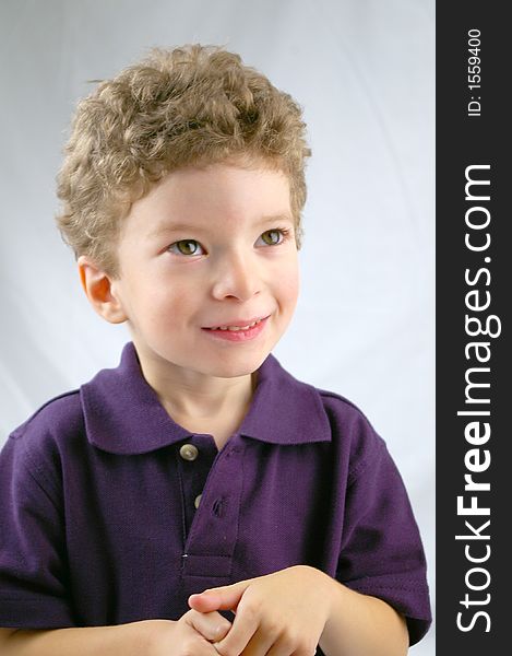 Toddler smiling and posing with violet shirt. Toddler smiling and posing with violet shirt
