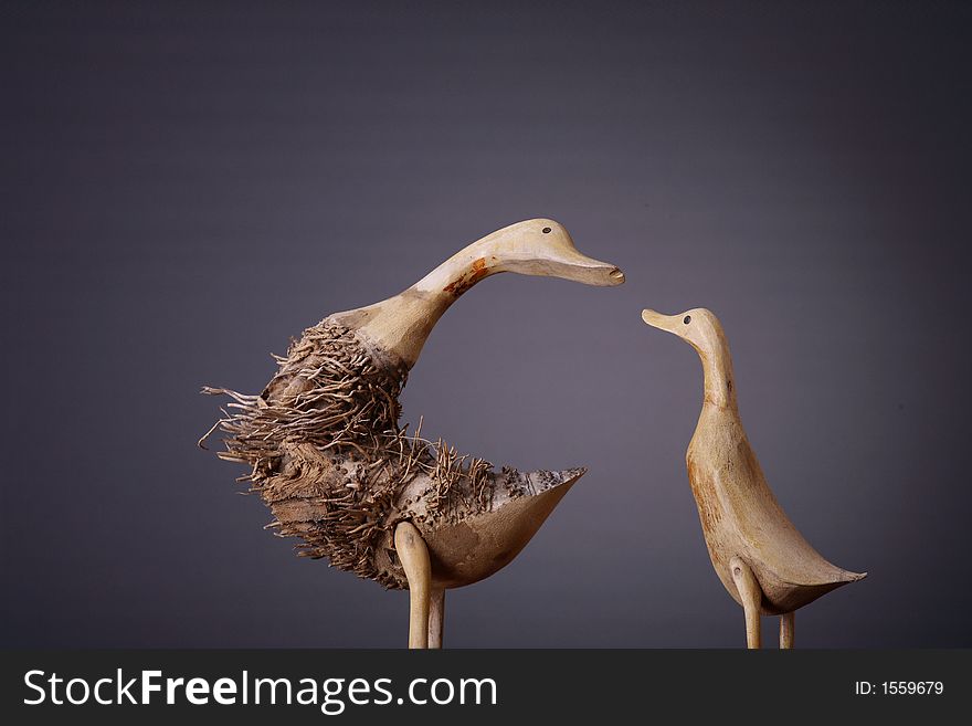 Wooden ducks shot over gray background. Wooden ducks shot over gray background