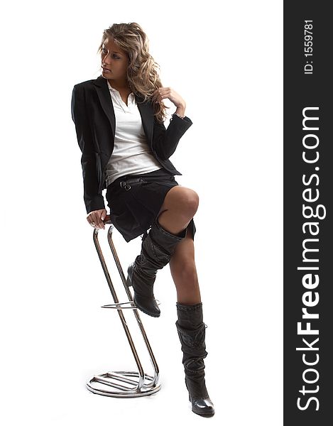 Great looking blond business woman shot in studio - on chair. Great looking blond business woman shot in studio - on chair