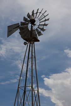 Rural Windmill Backlit Against Partly Cloudy Sky Stock Photos Rural Windmill Backlit Against Partly Cloudy Sky Stock Photos