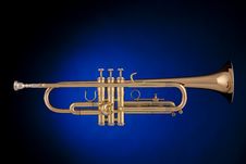 Gold Trumpet Isolated On Blue Stock Image