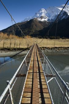 Swing Bridge Crossing To Snow Capped Mountains Royalty Free Stock Image Swing Bridge Crossing To Snow Capped Mountains Royalty Free Stock Image
