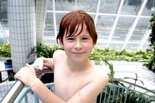 Young Boy With Red Hair Gets Out Of The Pool Stock Photo