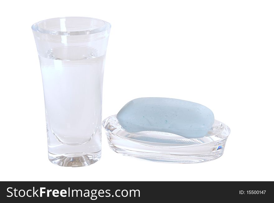 Glass full of water and soap bar isolated over white. Glass full of water and soap bar isolated over white.