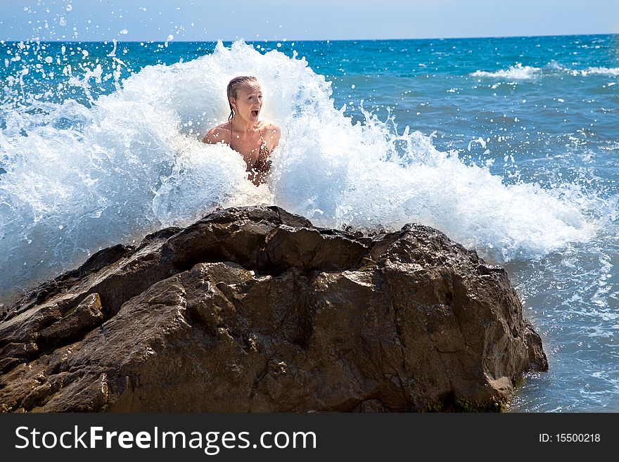 Young woman is in marine  waves