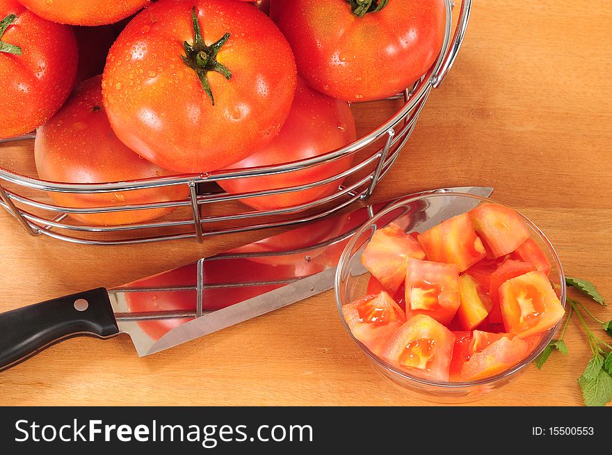 Chopped tomato and kitchen knife on cutting board. Chopped tomato and kitchen knife on cutting board.