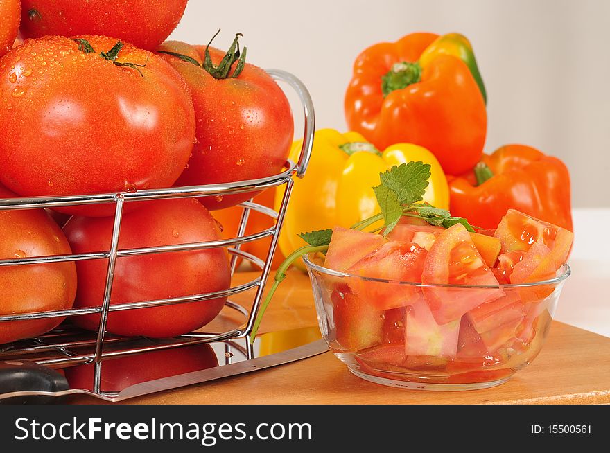 Chopped tomato and pepper bell on cutting board. Chopped tomato and pepper bell on cutting board.