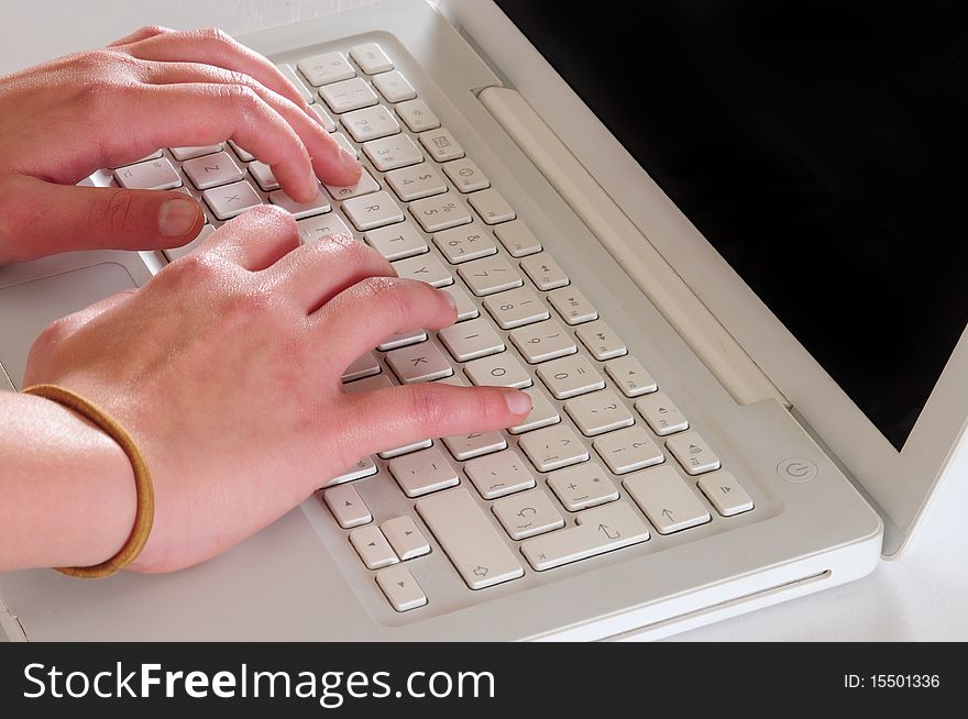 Typing on a white personal computer. Typing on a white personal computer.