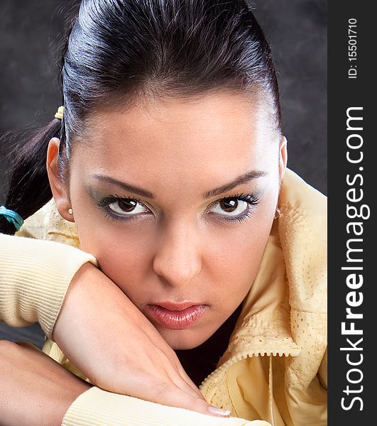 Pretty brunette in yellow posing , studio shot