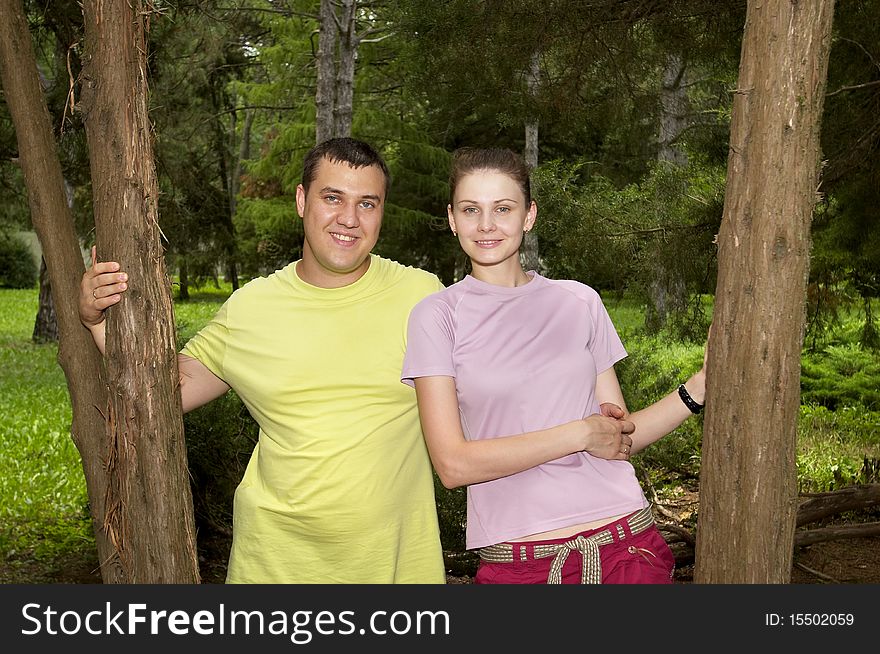 Young couple in the park over defocused background