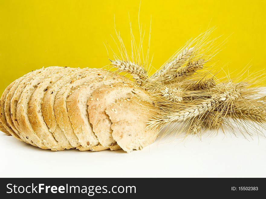 Bread and a few stalks of rye isolated. Bread and a few stalks of rye isolated
