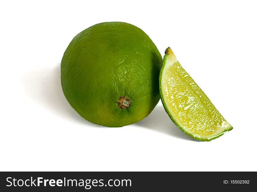 Lime and lime slice isolated on white.