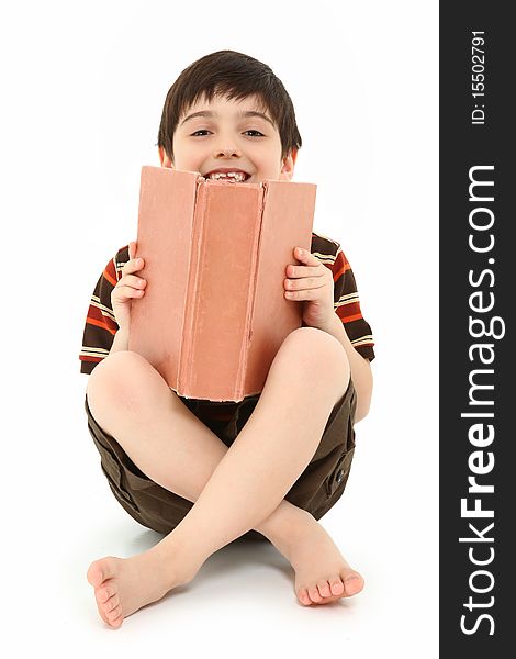 Casual happy seven year old french american boy with large book over white background. Casual happy seven year old french american boy with large book over white background.