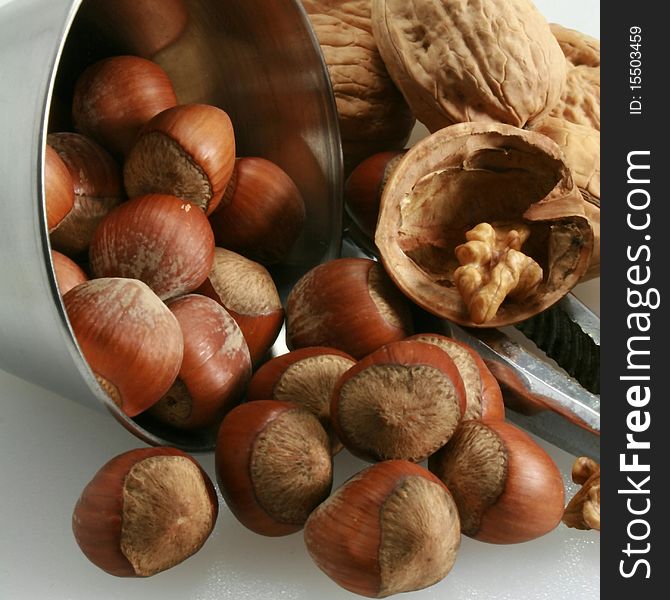 Basket of walnuts and hazelnuts after a walk in forest during autumn